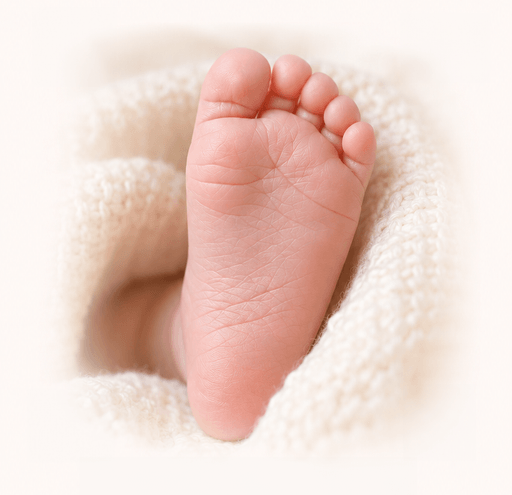 A newborn's foot, sole up, in soft natural light